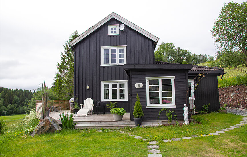 Black house with white details with garden