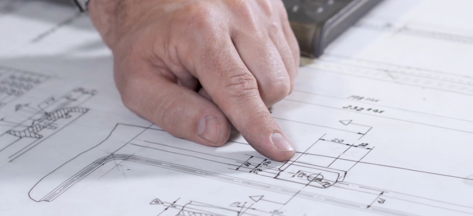 Hand pointing at Jøtul process drawings