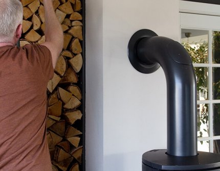 Man taking wood to put in the fireplace