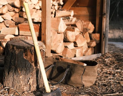 Wood shed with ax and chopping block in front