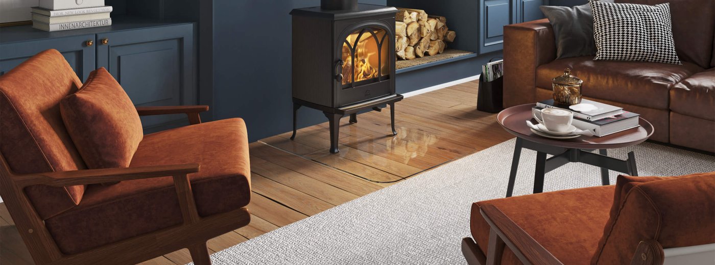Jøtul F 200 wood stove in black cast iron in a living room with dark blue walls