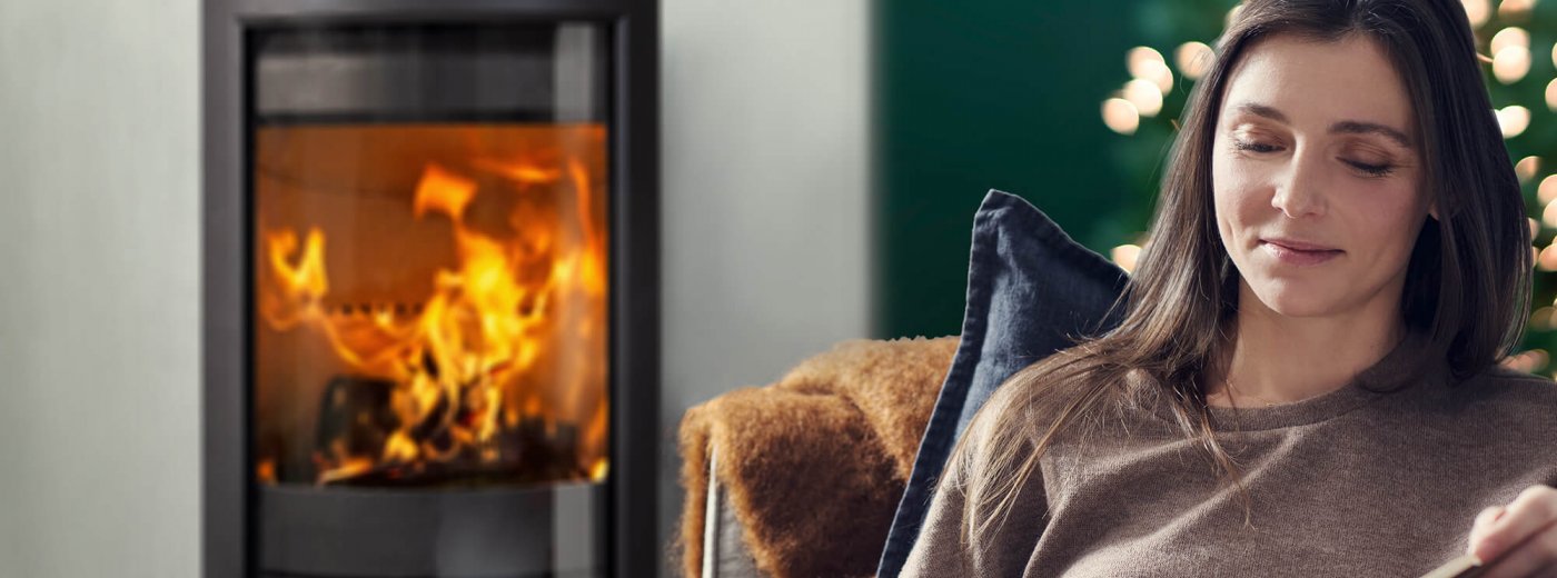 Christmas with woman in front of a fireplace