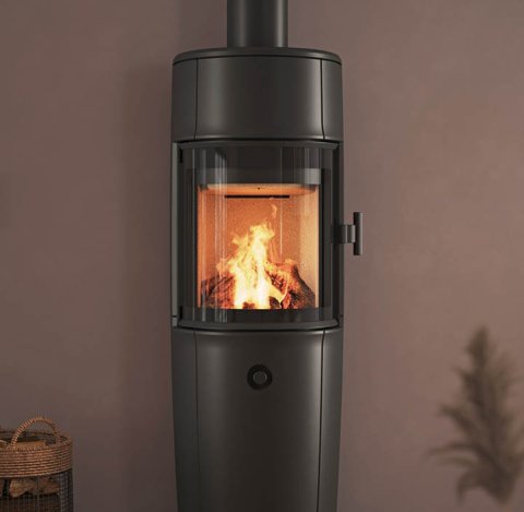 Modern room with large black Jøtul F 174 wood stove, powder-purple walls