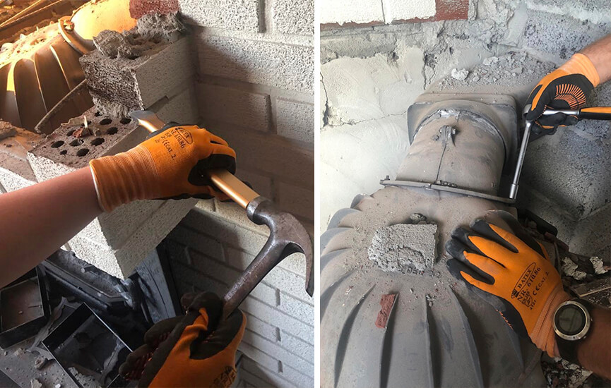 Hands working on removing an old fireplace.